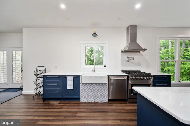 a kitchen with a stove a sink and a window