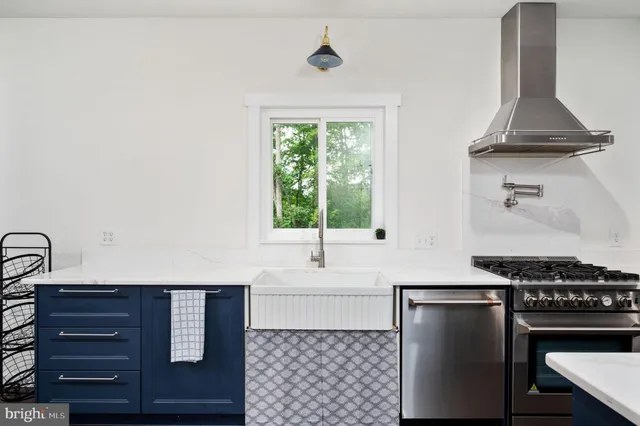 a large kitchen with granite countertop lots of counter space dining table and stainless steel appliances