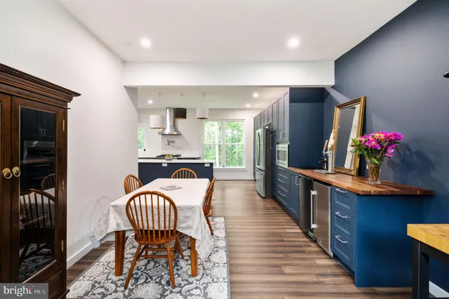 a view of walk in closet with window and hardwood floor