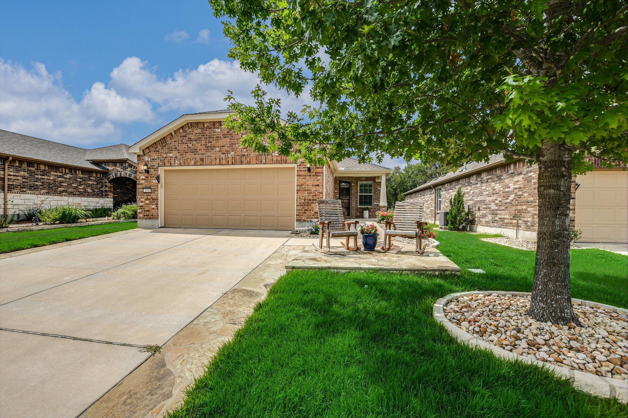 231 Hobby Street Georgetown, TX 78633 - Photo 1 of 29 Brick facade and mature tree adorn the welcoming exterior of this delightful residence.