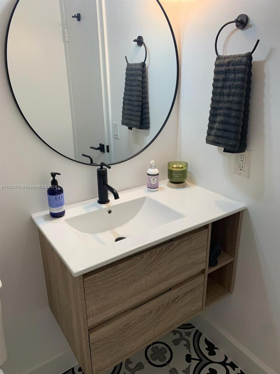 4590 Southwest 68th Ct Circle, Unit 4 Miami, FL 33155 - Photo 14 of 32 a bathroom with a sink and a mirror