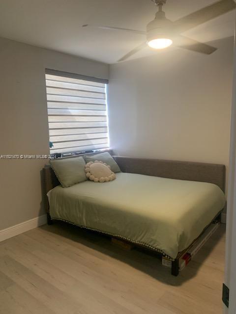 4590 Southwest 68th Ct Circle, Unit 4 Miami, FL 33155 - Photo 16 of 32 a bedroom with a bed and a night stand
