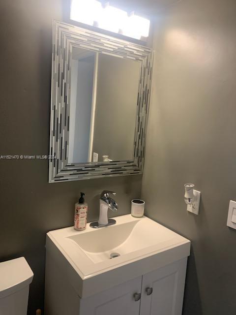 4590 Southwest 68th Ct Circle, Unit 4 Miami, FL 33155 - Photo 23 of 32 a bathroom with a sink and a mirror