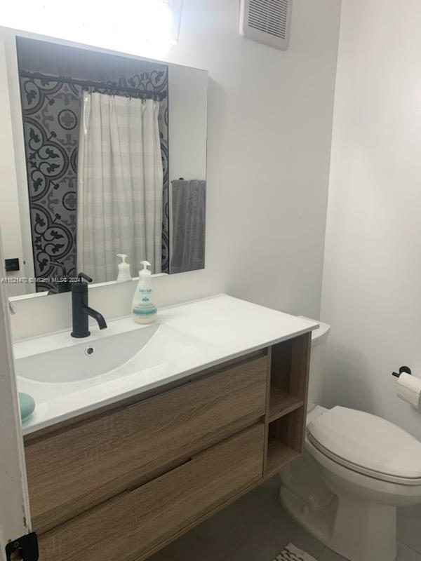4590 Southwest 68th Ct Circle, Unit 4 Miami, FL 33155 - Photo 25 of 32 a bathroom with a sink and a toilet