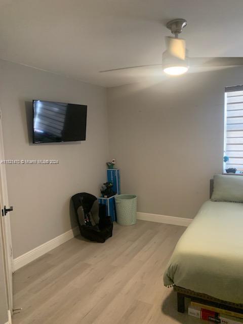 4590 Southwest 68th Ct Circle, Unit 4 Miami, FL 33155 - Photo 29 of 32 a bedroom with a bed and a flat screen tv