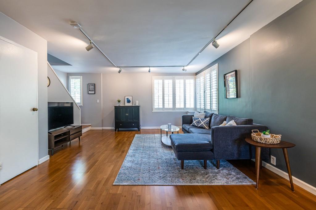 1188 Briarcliff Road Northeast, Unit 3 Atlanta, GA 30306 - Photo 1 of 1 a living room with furniture and a flat screen tv