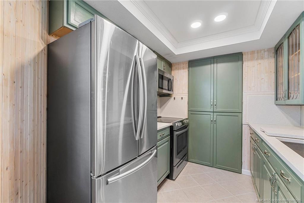 3218 Southeast Aster Lane, Unit P116 Stuart, FL 34994 - Photo 12 of 45 a kitchen with stainless steel appliances granite countertop a refrigerator and a sink