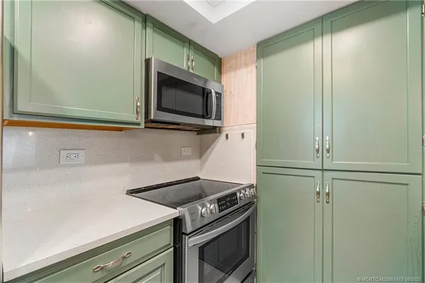 a kitchen with a stove and a microwave