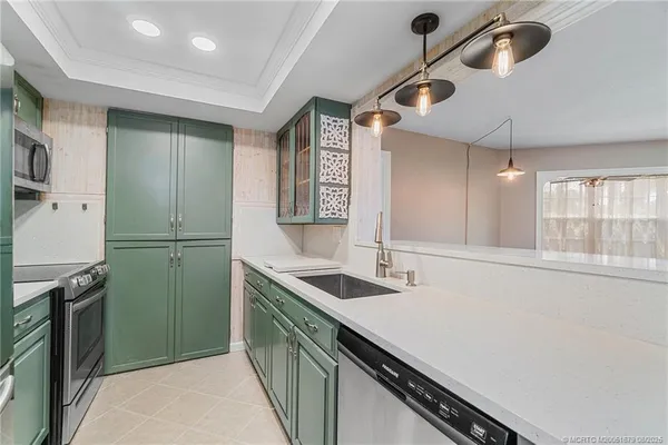 a kitchen with sink cabinets and refrigerator