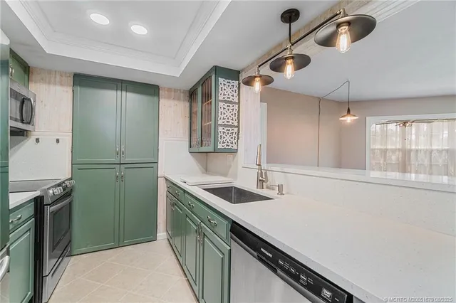 a kitchen with sink cabinets and refrigerator
