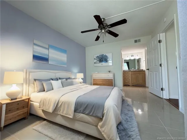 a spacious bedroom with a bed and a chandelier