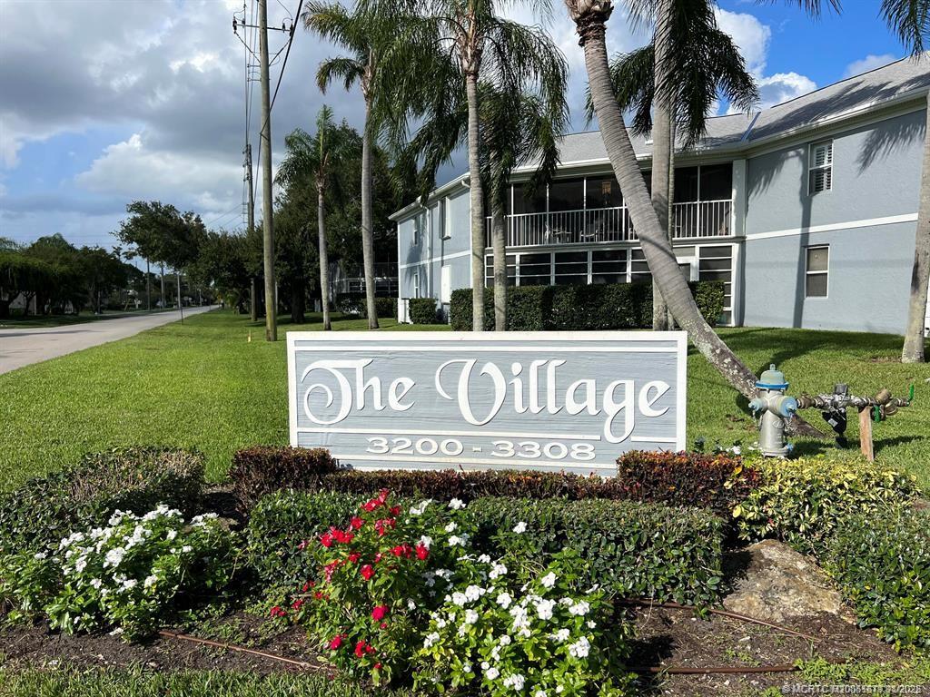 3218 Southeast Aster Lane, Unit P116 Stuart, FL 34994 - Photo 2 of 45 a view of sign board with yard and lake view