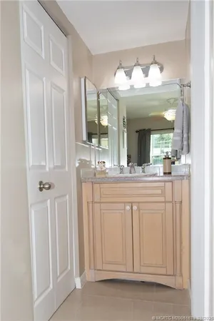 a bathroom with a sink vanity and a mirror