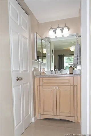 a bathroom with a sink vanity and a mirror