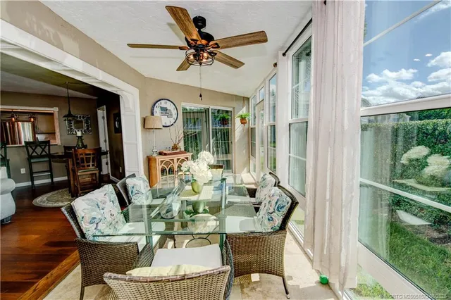 a dining room with furniture a rug and a large window