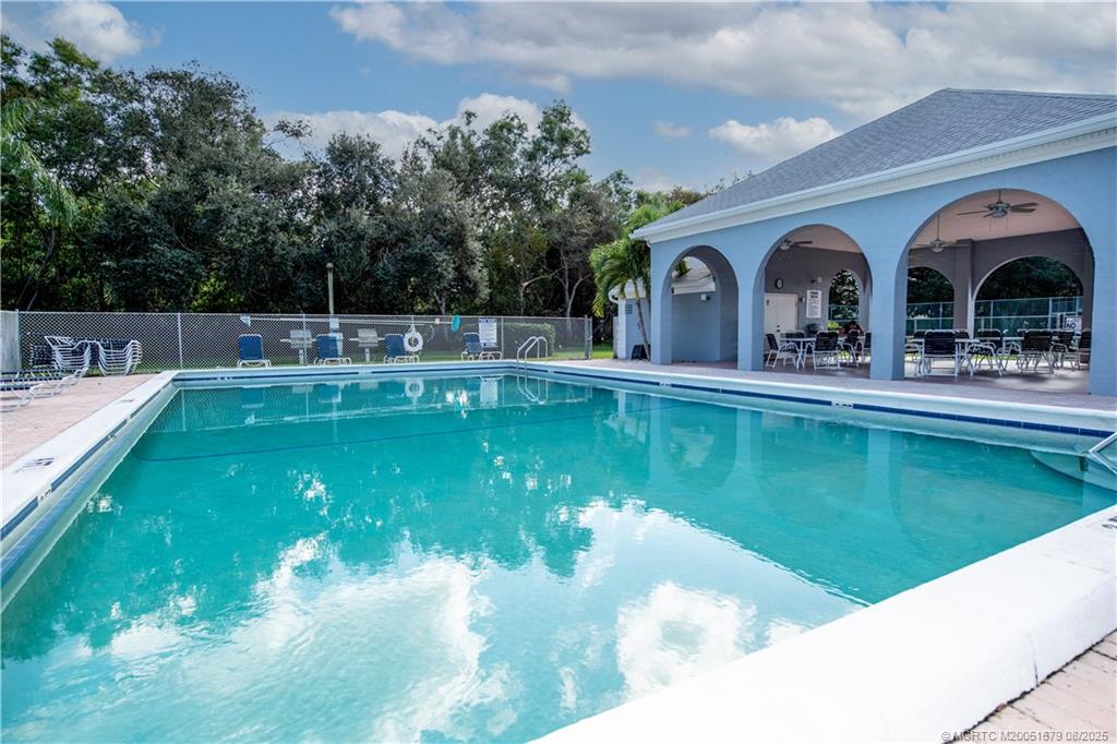 3218 Southeast Aster Lane, Unit P116 Stuart, FL 34994 - Photo 3 of 45 a view of a swimming pool with a garden