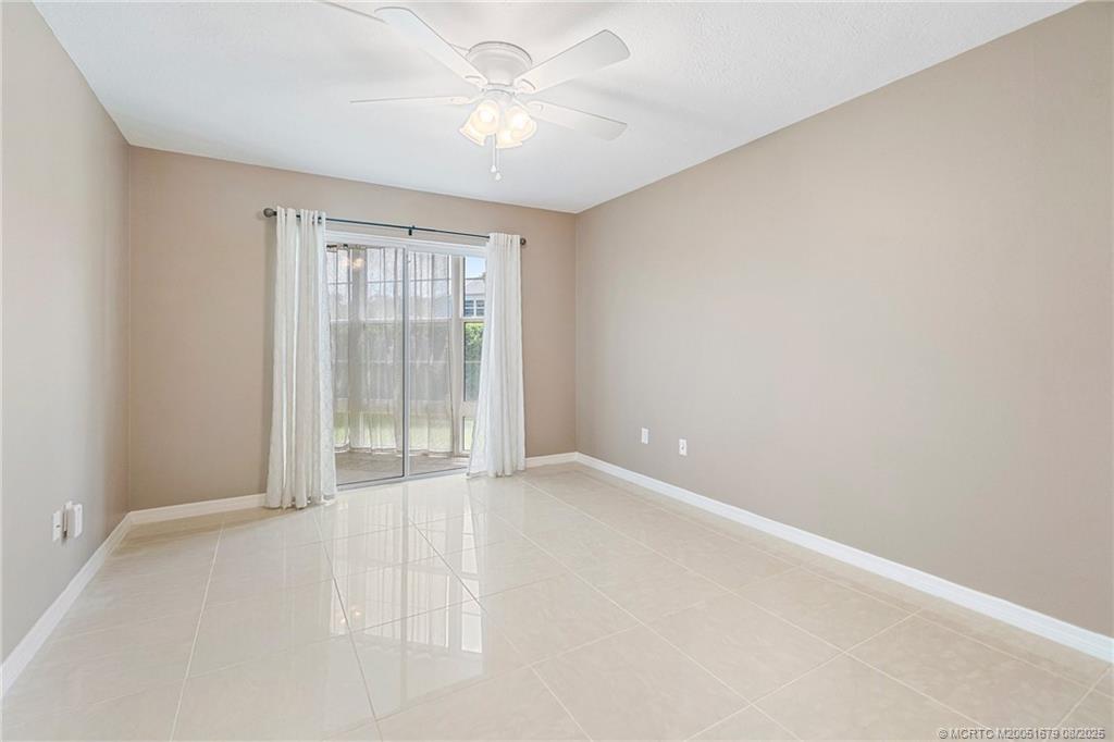 3218 Southeast Aster Lane, Unit P116 Stuart, FL 34994 - Photo 37 of 45 an empty room with chandelier fan