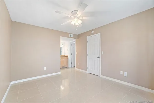 a view of an empty room with a ceiling fan