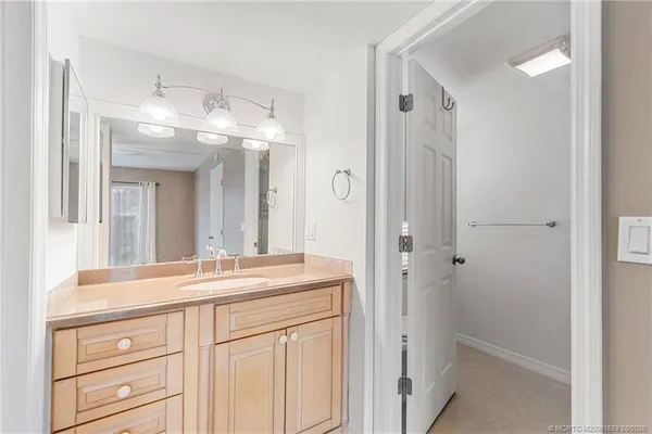 a bathroom with a sink vanity and a mirror