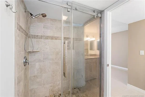 a bathroom that has a glass shower door