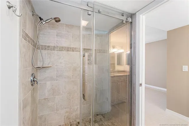a bathroom that has a glass shower door
