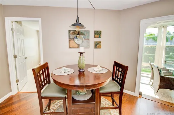 a view of a dining room with furniture window and wooden floor