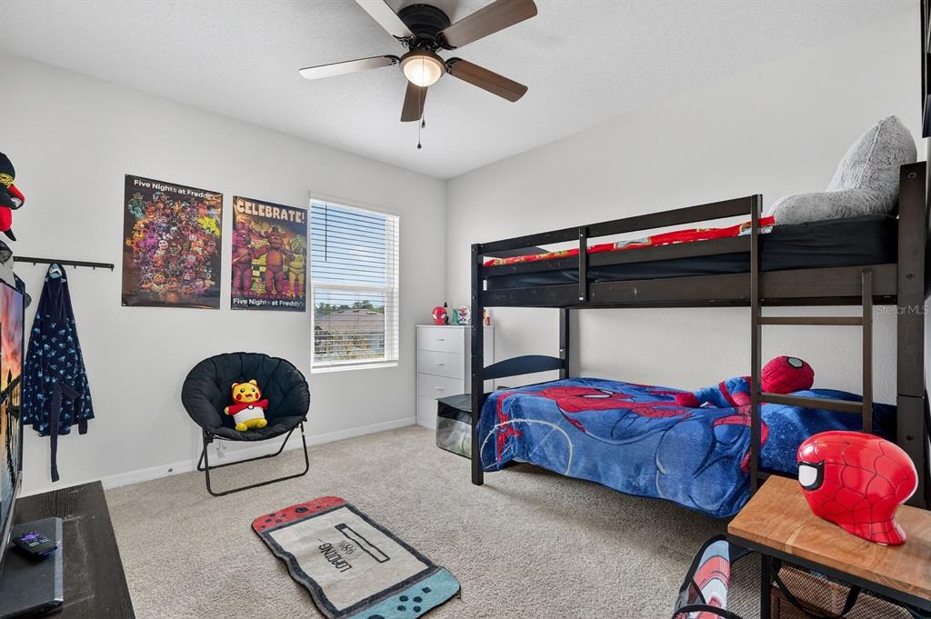 1809 Myrtlebrooke Drive Edgewater, FL 32141 - Photo 28 of 58 a bedroom with two beds and a chandelier