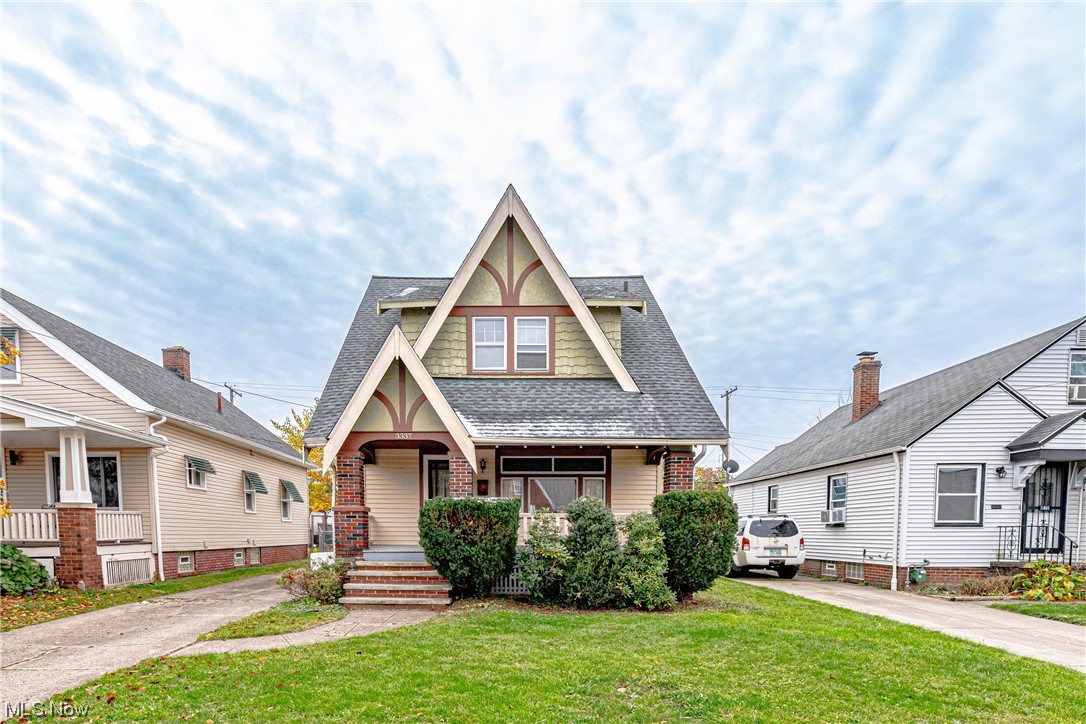3337 Ralph Avenue Cleveland, OH 44109 - Photo 1 of 30 View of front of house with a front lawn and covered porch