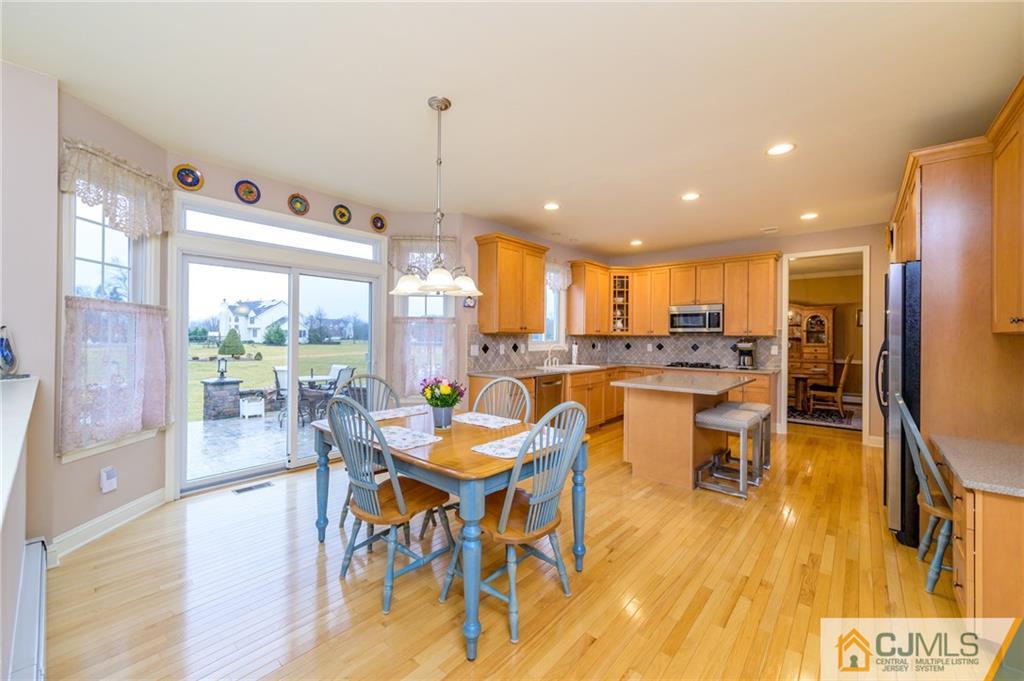 3 Victoria Court Cream Ridge, NJ 08514 - Photo 11 of 38 a dining room with furniture a large window and wooden floor