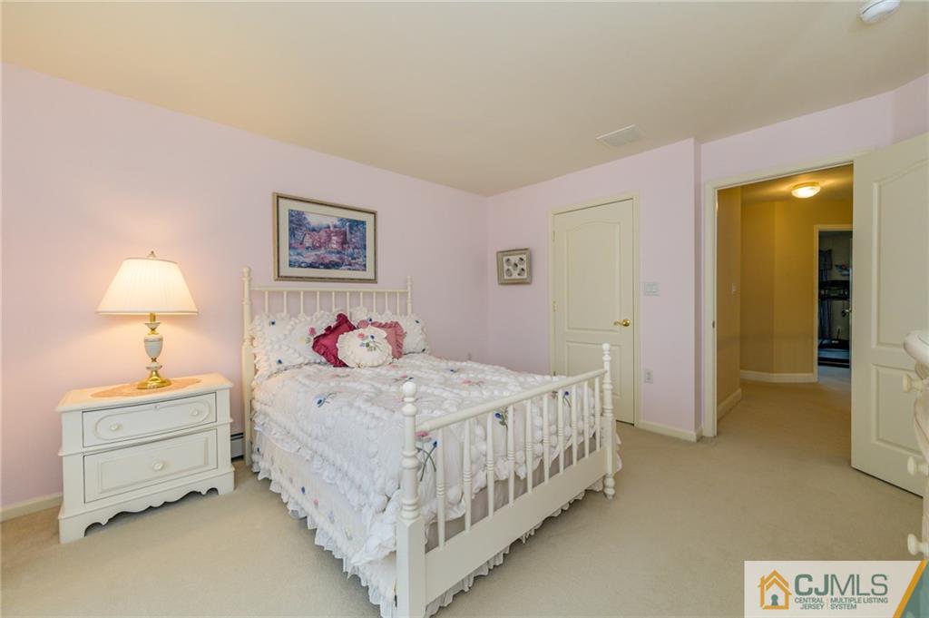 3 Victoria Court Cream Ridge, NJ 08514 - Photo 19 of 38 a bedroom with a bed and a lamp