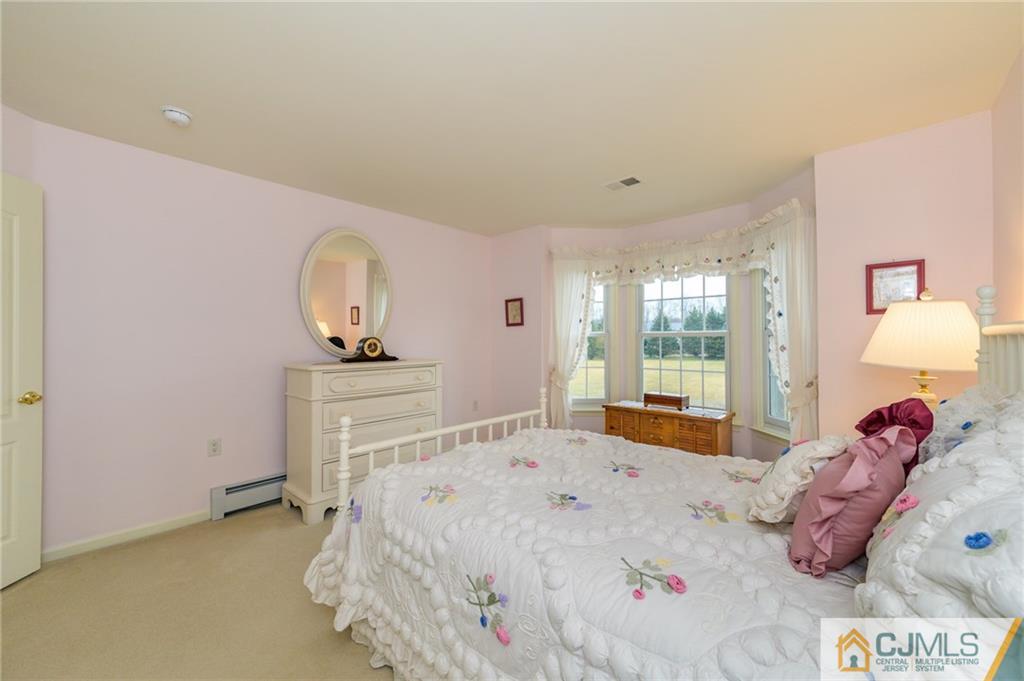 3 Victoria Court Cream Ridge, NJ 08514 - Photo 20 of 38 a bedroom with a bed and a mirror