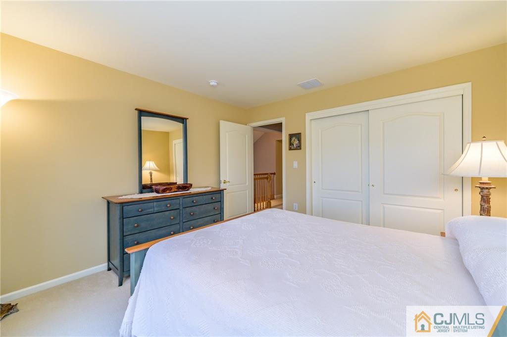 3 Victoria Court Cream Ridge, NJ 08514 - Photo 22 of 38 a bed room with a bed and a lamp