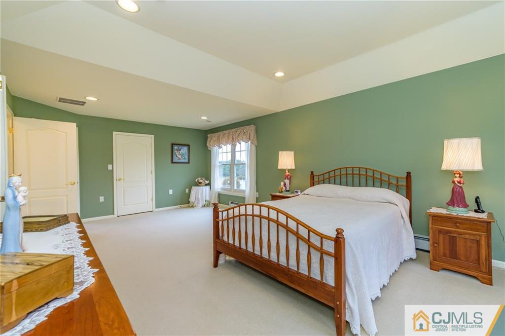 3 Victoria Court Cream Ridge, NJ 08514 - Photo 26 of 38 a bedroom with a bed and a lamp with the dresser
