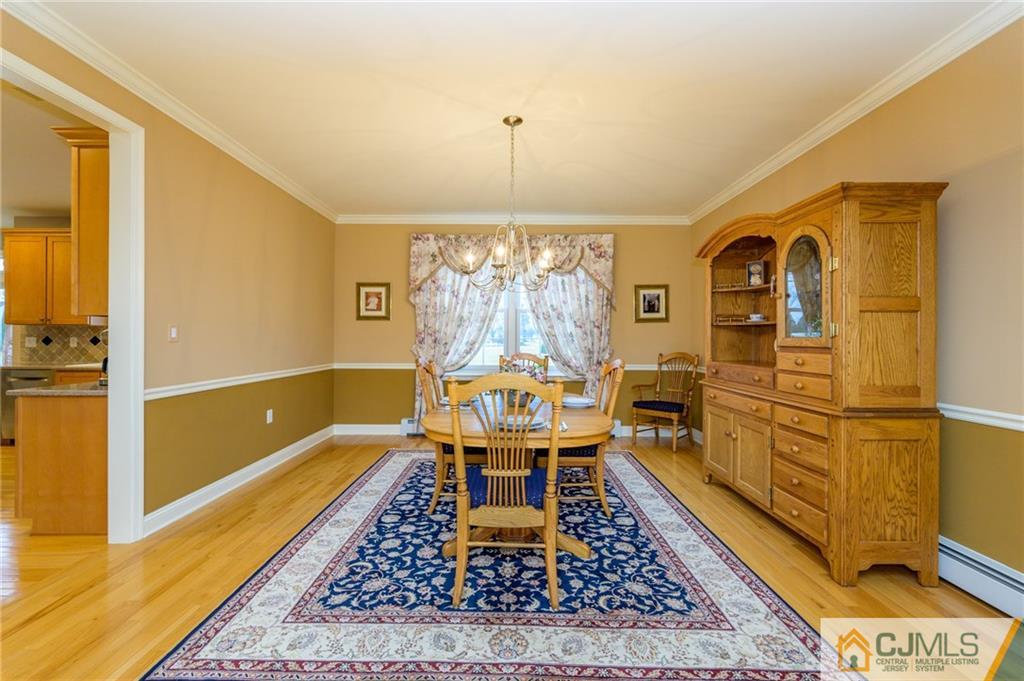 3 Victoria Court Cream Ridge, NJ 08514 - Photo 8 of 38 a living room with furniture and a chandelier