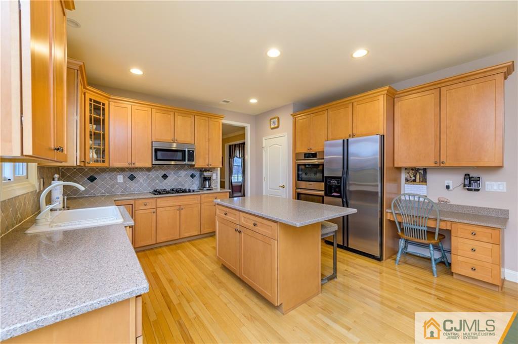 3 Victoria Court Cream Ridge, NJ 08514 - Photo 9 of 38 a large kitchen with kitchen island granite countertop a stove top oven a sink dishwasher a dining table and chairs with wooden floor