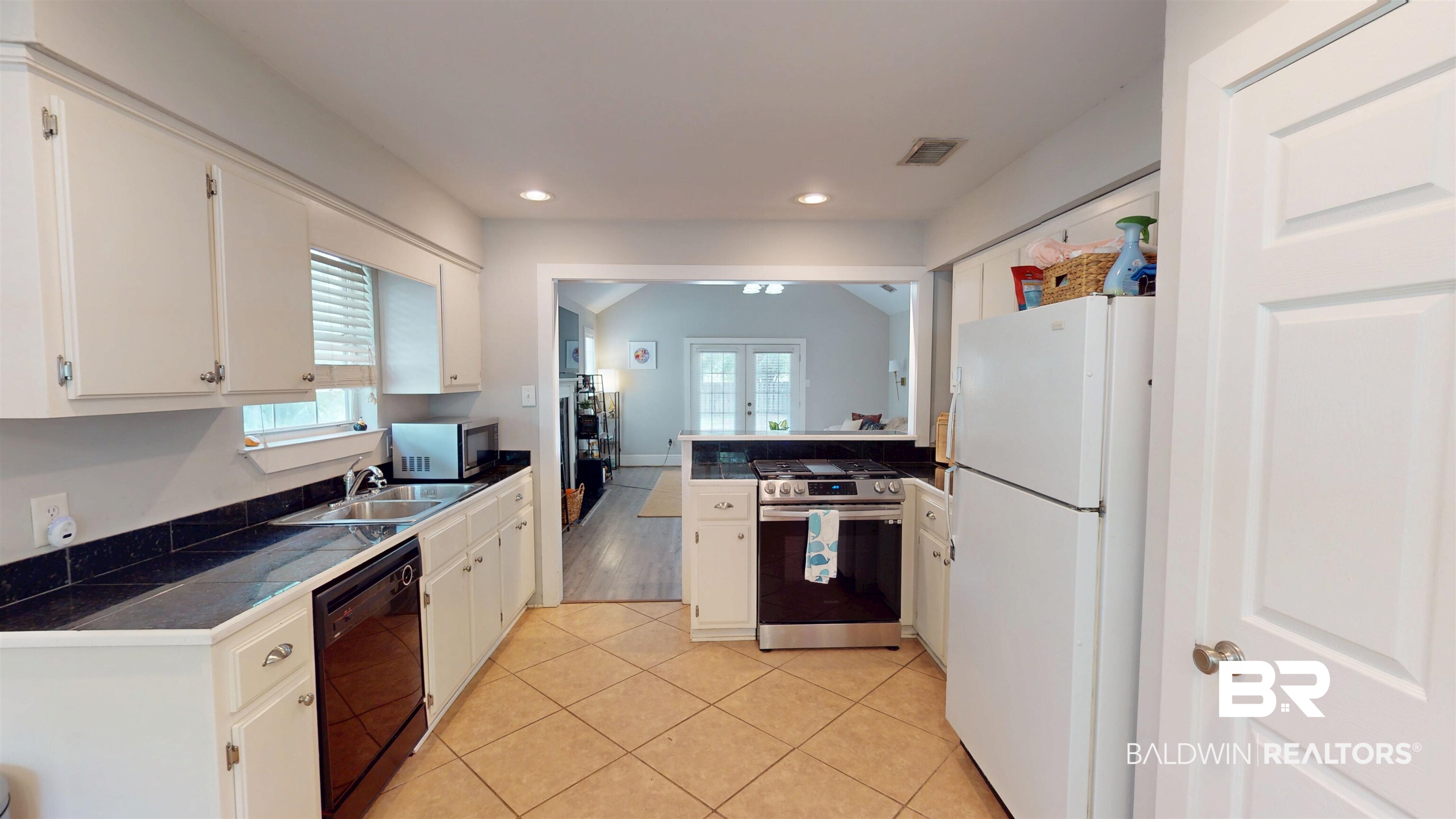 51 Bishop Lane South Mobile, AL 36608 - Photo 5 of 19 Kitchen featuring appliances with stainless steel finishes, light tile patterned flooring, white cabinets, french doors, and recessed lighting