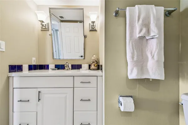 a bathroom with a double vanity sink toilet and shower