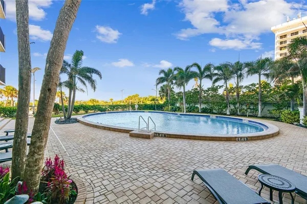 a kitchen with stainless steel appliances kitchen island granite countertop a dining table chairs and granite counter tops