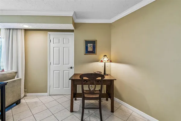 a living room with furniture and large windows