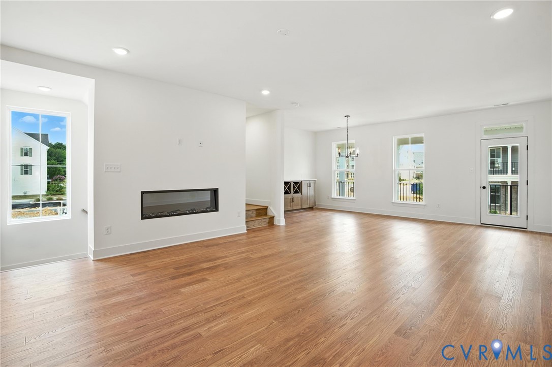 11927 Evening Loop Henrico, VA 23233 - Photo 11 of 37 a view of an empty room with window and wooden floor