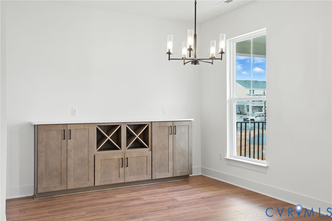 11927 Evening Loop Henrico, VA 23233 - Photo 13 of 37 an empty room with wooden floor cabinet and windows