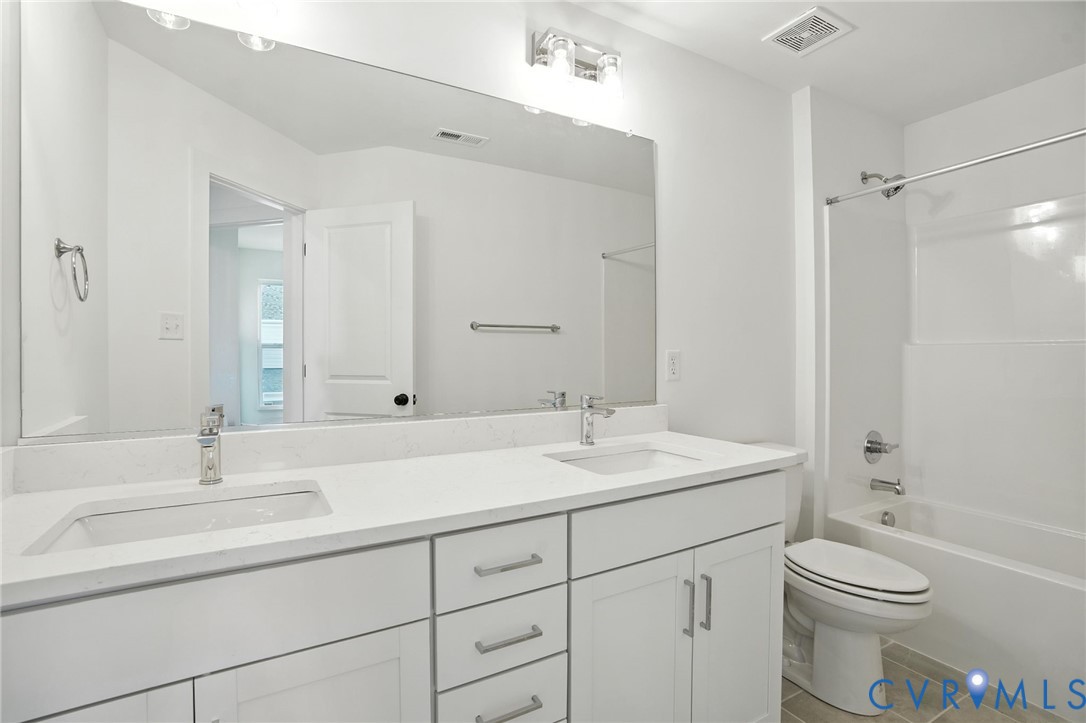 11927 Evening Loop Henrico, VA 23233 - Photo 23 of 37 a bathroom with a sink a toilet and shower