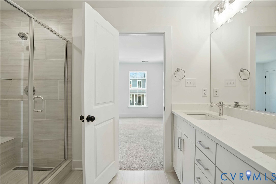 11927 Evening Loop Henrico, VA 23233 - Photo 4 of 37 a spacious bathroom with a shower sink and mirror