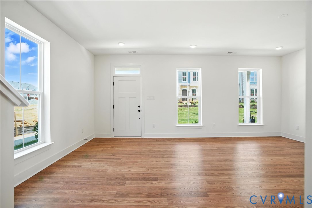 11927 Evening Loop Henrico, VA 23233 - Photo 8 of 37 a view of an empty room with wooden floor and a window