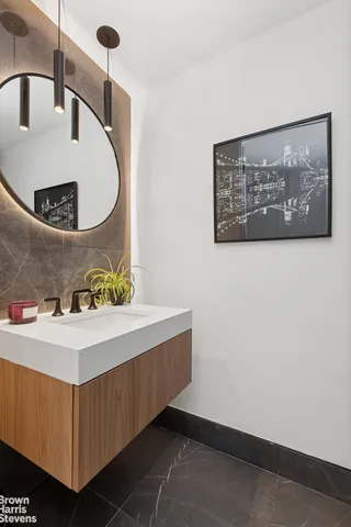 a bathroom with a sink a toilet and mirror