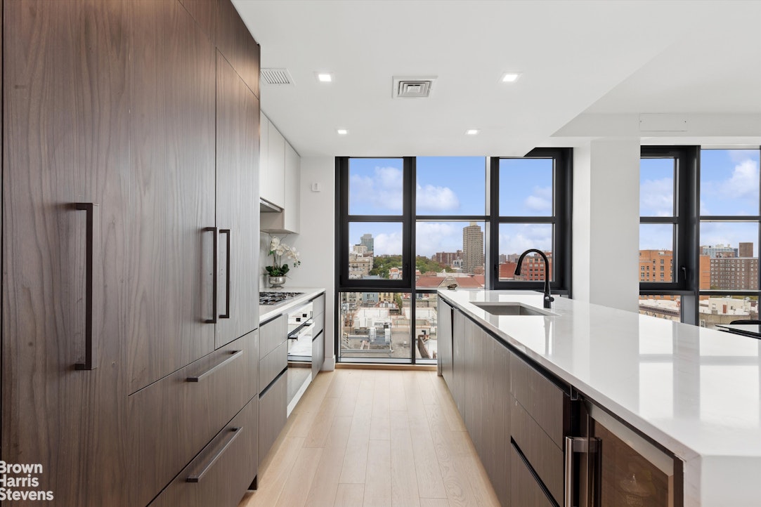 11 Hancock Place, Unit PH206 Manhattan, NY 10027 - Photo 3 of 14 a large kitchen with stainless steel appliances a large counter top a stove and a refrigerator