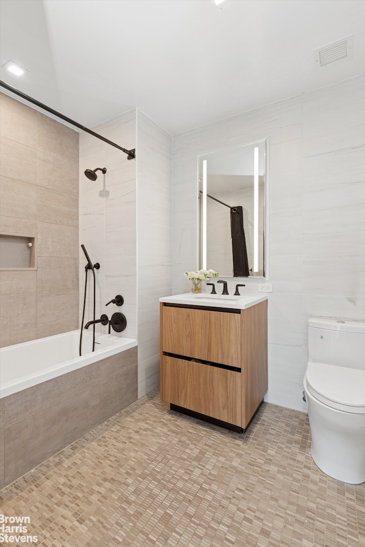 11 Hancock Place, Unit PH206 Manhattan, NY 10027 - Photo 9 of 14 a bathroom with a sink a toilet and mirror