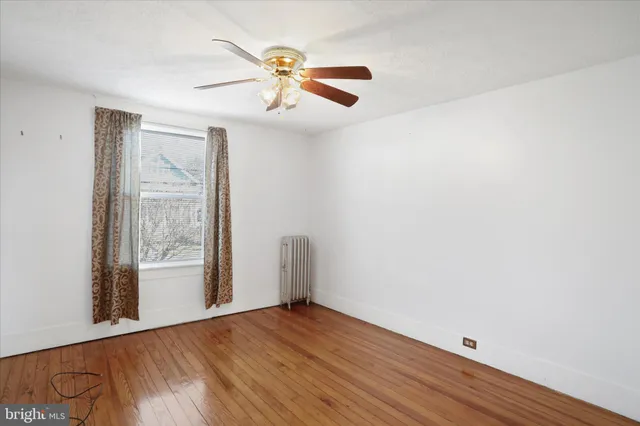 a view of a house with a yard covered in the forest