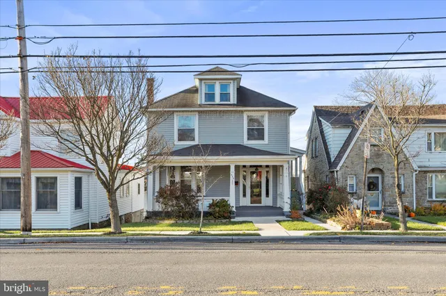a front view of a house with a view of a yard