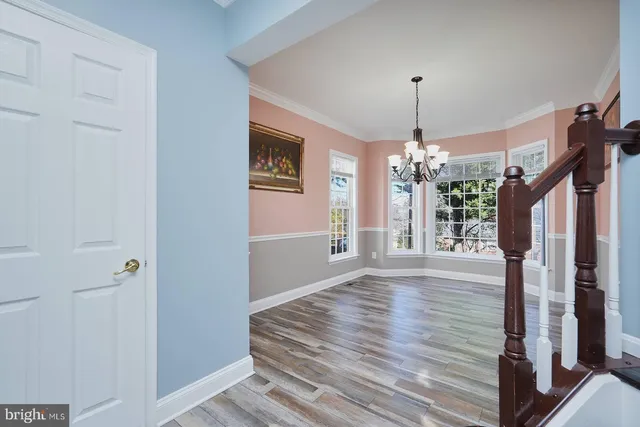 a view of a livingroom with wooden floor and chandelier